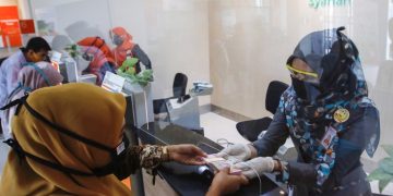 Petugas BNI Syariah Kantor Cabang Banda Aceh sedang melayani transaksi nasabah, Senin (19/10).